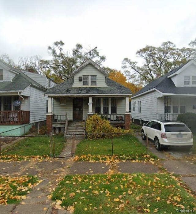 5586 Lemay St, Detroit, MI 48213 - view of front of property featuring a porch, a fenced front yard, and a gate