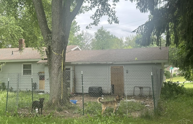 2220 Alice St, Farwell, MI 48622 - back of house featuring a chimney and a shingled roof