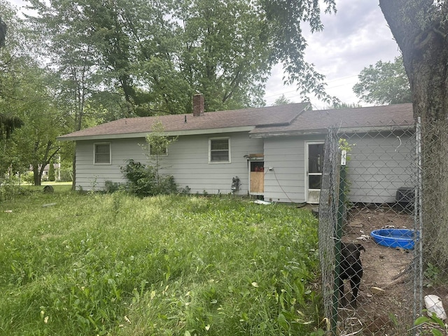 2220 Alice St, Farwell, MI 48622 - back of property featuring a chimney