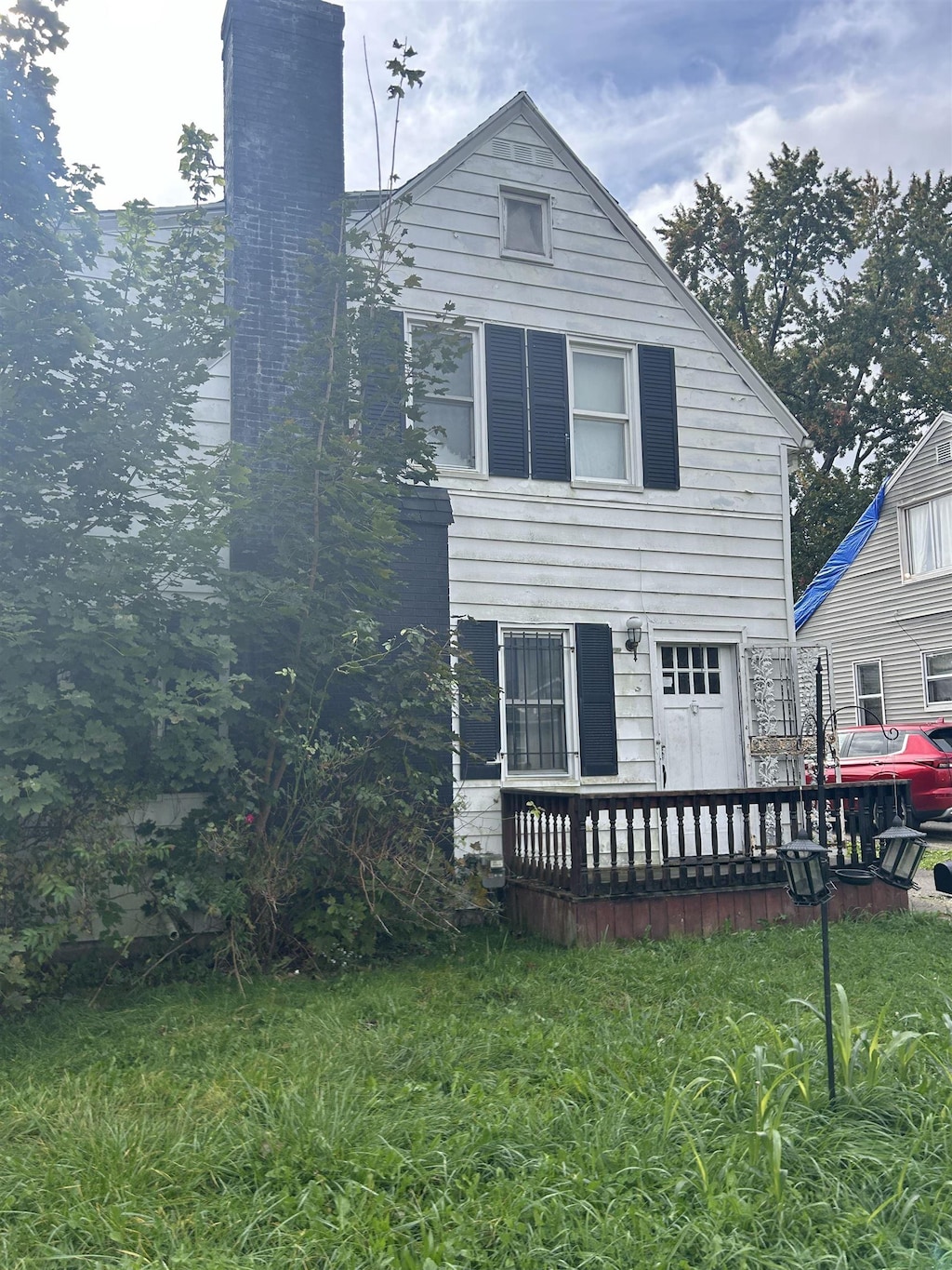 2223 Begole St, Flint, MI 48504 - back of house featuring a chimney and a deck