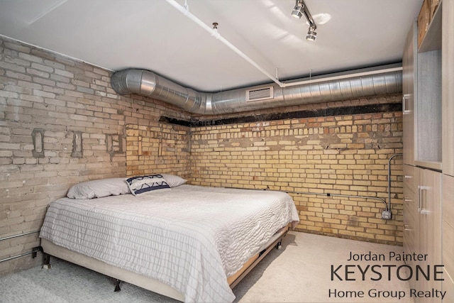 600 Broadway Ave NW Unit 409B, Grand Rapids, MI 49504 - carpeted bedroom with brick wall