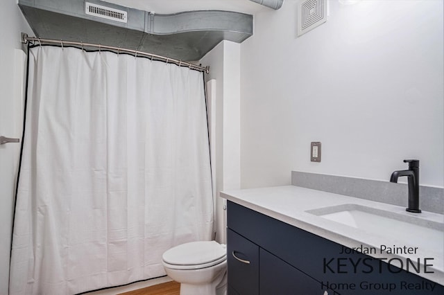 600 Broadway Ave NW Unit 409B, Grand Rapids, MI 49504 - full bathroom featuring vanity, curtained shower, and wood finished floors