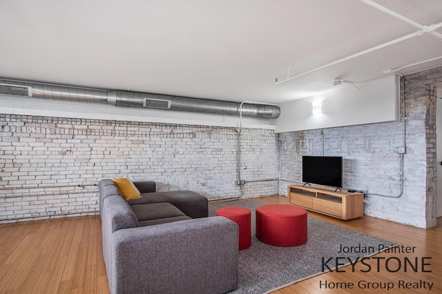 600 Broadway Ave NW Unit 409B, Grand Rapids, MI 49504 - living area with brick wall and wood finished floors