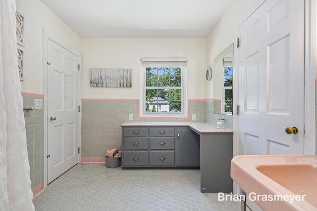 539 Overbrook Ln SE, Grand Rapids, MI 49507 - bathroom featuring tile walls, a wainscoted wall, and vanity