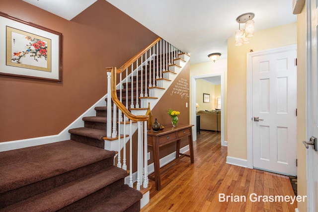 539 Overbrook Ln SE, Grand Rapids, MI 49507 - stairway featuring baseboards and wood finished floors