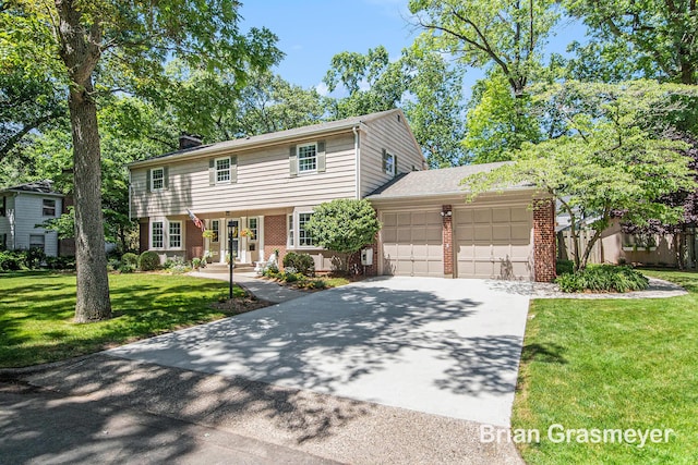 539 Overbrook Ln SE, Grand Rapids, MI 49507 - colonial house with an attached garage, brick siding, driveway, a front yard, and a chimney