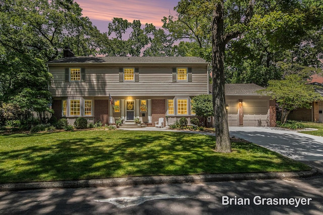 539 Overbrook Ln SE, Grand Rapids, MI 49507 - colonial home featuring driveway, brick siding, a chimney, an attached garage, and a yard
