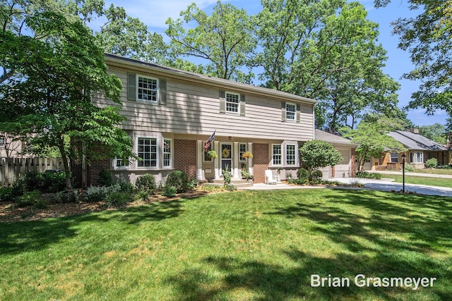 539 Overbrook Ln SE, Grand Rapids, MI 49507 - colonial inspired home with a garage, brick siding, and driveway