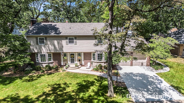 539 Overbrook Ln SE, Grand Rapids, MI 49507 - colonial house with driveway, a front lawn, brick siding, and a garage