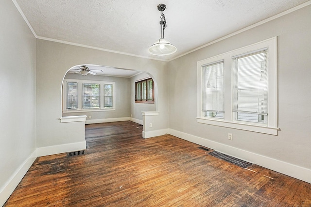 1921 Cornelius Ave SE, Grand Rapids, MI 49507 - empty room with crown molding, wood finished floors, arched walkways, ceiling fan, and a textured ceiling