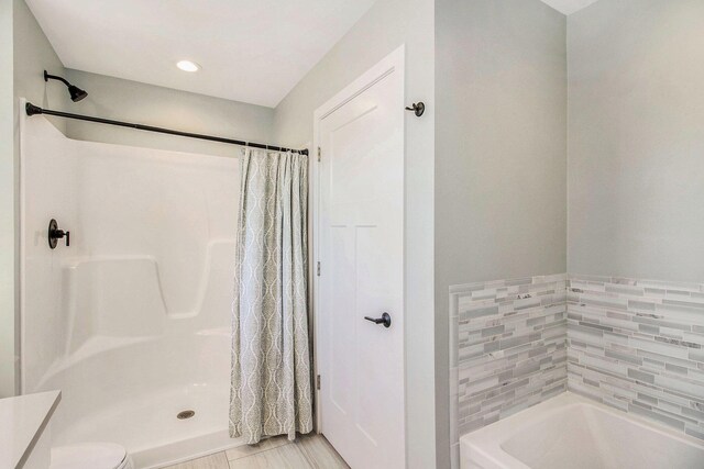 11539 Warrior Trl, Grass Lake, MI 49240 - full bathroom featuring a bath and curtained shower