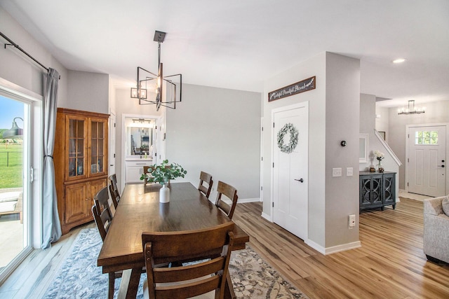 11539 Warrior Trl, Grass Lake, MI 49240 - dining room with a chandelier, light wood-style flooring, and recessed lighting
