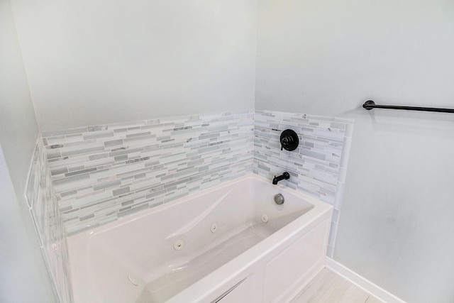 11539 Warrior Trl, Grass Lake, MI 49240 - bathroom with a jetted tub and baseboards