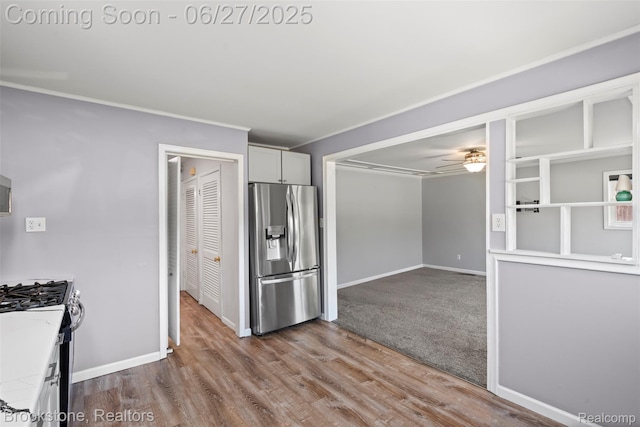 1293 Moulin Ave, Madison Heights, MI 48071 - kitchen with stainless steel fridge with ice dispenser, gas range oven, a ceiling fan, wood finished floors, and light countertops