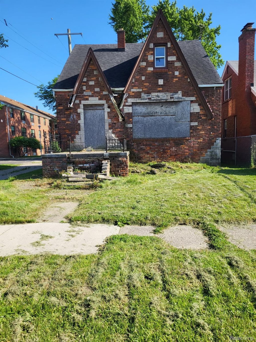 14966 Elmdale St, Grosse Pointe, MI 48213 - tudor house with a front lawn, a shingled roof, a chimney, and brick siding