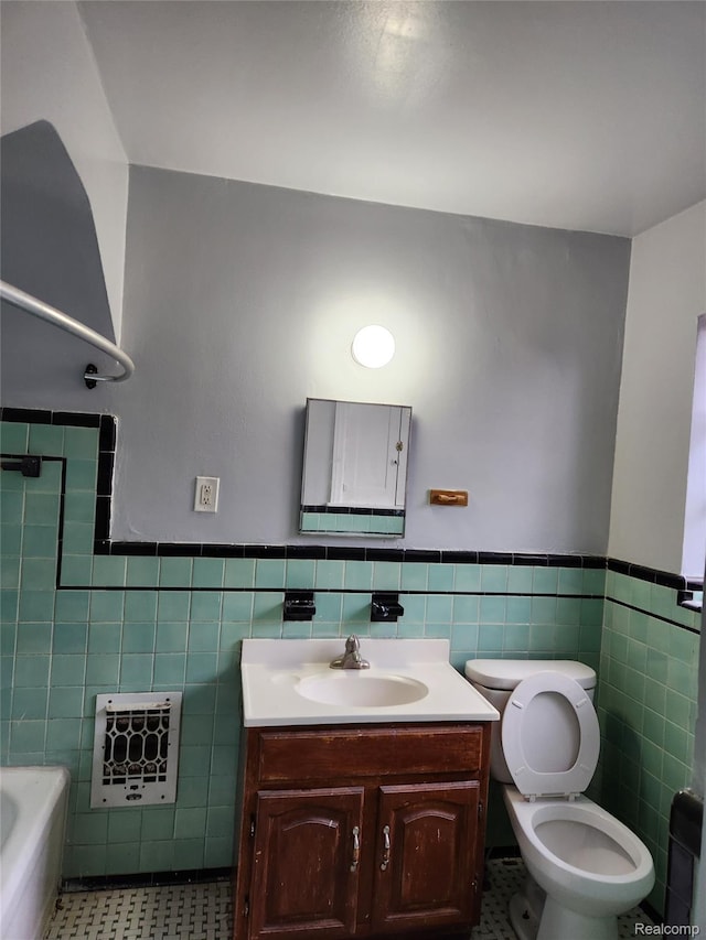 14119 Whitcomb St, Detroit, MI 48227 - bathroom with tile walls, heating unit, vanity, wainscoting, and tile patterned floors