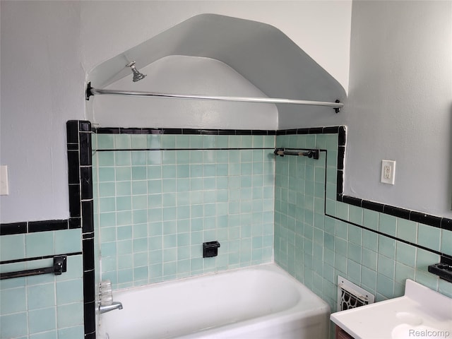 14119 Whitcomb St, Detroit, MI 48227 - bathroom with tile walls, vanity, and bathtub / shower combination