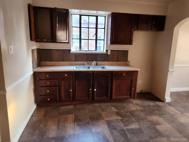 14119 Whitcomb St, Detroit, MI 48227 - kitchen featuring arched walkways, dark brown cabinetry, and light countertops