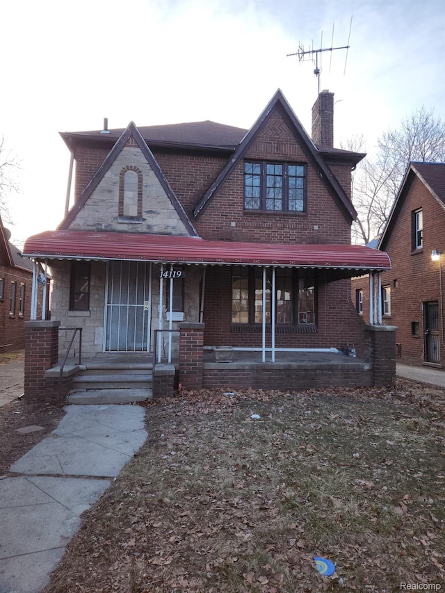 14119 Whitcomb St, Detroit, MI 48227 - view of front of house featuring a porch, a chimney, and brick siding