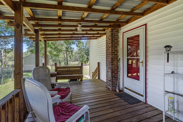 1645 Chlebus St, Jackson, MI 49203 - wooden terrace with outdoor dining area and a storage unit