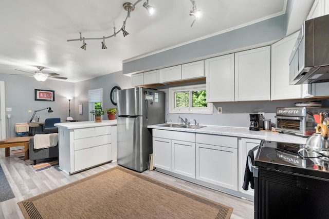 1645 Chlebus St, Jackson, MI 49203 - kitchen featuring stainless steel appliances, light countertops, a peninsula, and light wood finished floors