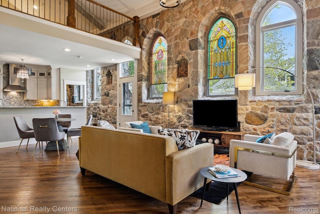 229 E Commerce St Unit 1, Milford, MI 48381 - living area with wood finished floors, healthy amount of natural light, a chandelier, and a towering ceiling