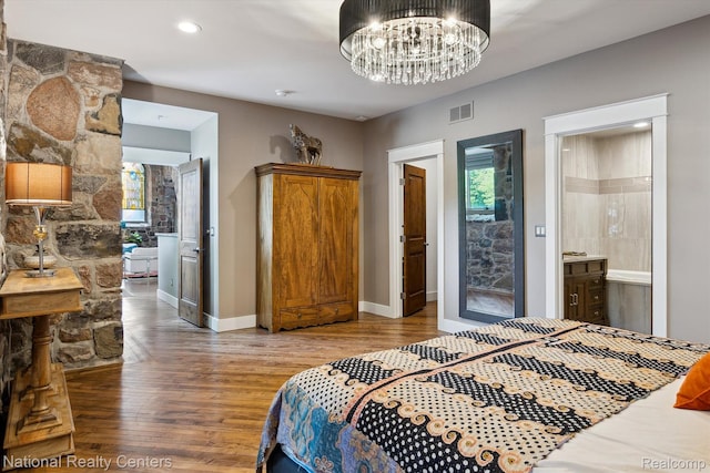 229 E Commerce St Unit 1, Milford, MI 48381 - bedroom featuring wood finished floors, a chandelier, and recessed lighting
