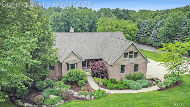 4301 Rolling Acres Dr, Hartland, MI 48353 - view of front of house featuring a front lawn, a shingled roof, and a chimney