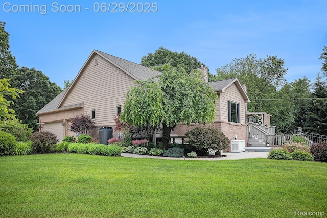 4301 Rolling Acres Dr, Hartland, MI 48353 - view of side of property featuring brick siding, a yard, a chimney, and a garage