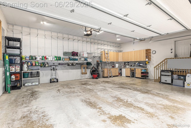 4301 Rolling Acres Dr, Hartland, MI 48353 - garage with a garage door opener and a workshop area