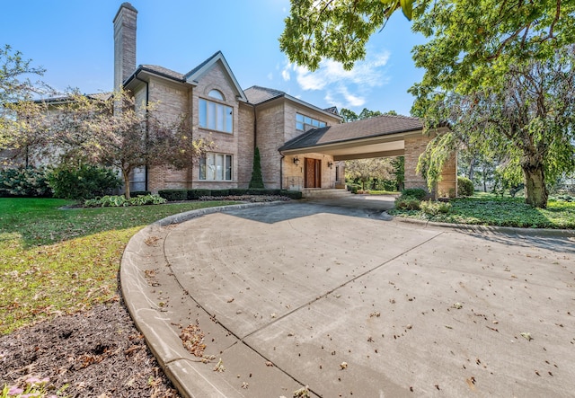 861 S 800 W, Indiana, IN 46341 - traditional-style house with a chimney, brick siding, concrete driveway, and a front lawn