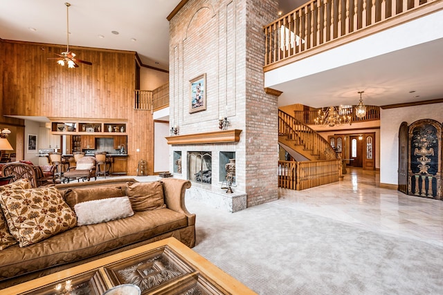 861 S 800 W, Indiana, IN 46341 - living area featuring a towering ceiling, a fireplace, stairway, wood walls, and a ceiling fan
