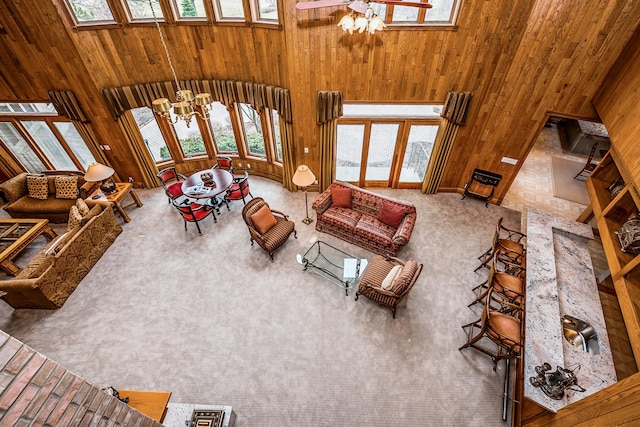 861 S 800 W, Indiana, IN 46341 - carpeted living room featuring a towering ceiling, plenty of natural light, wooden walls, and ceiling fan