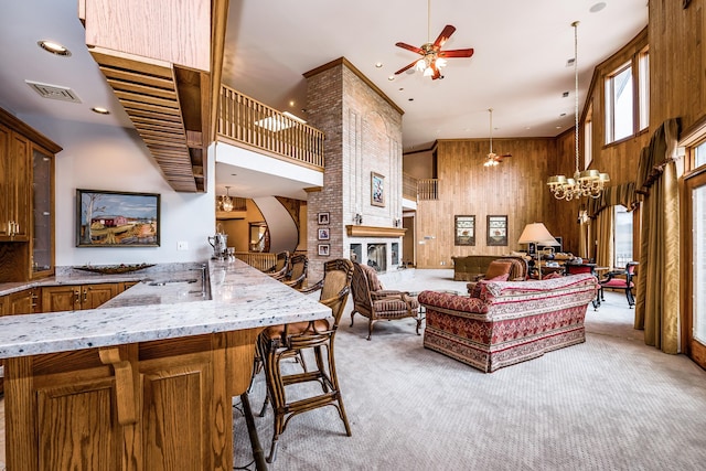 861 S 800 W, Indiana, IN 46341 - living area featuring ceiling fan, a towering ceiling, light colored carpet, a chandelier, and wooden walls
