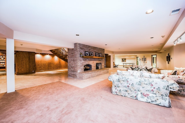 861 S 800 W, Indiana, IN 46341 - living room featuring stairs, a fireplace, carpet, track lighting, and tile patterned flooring