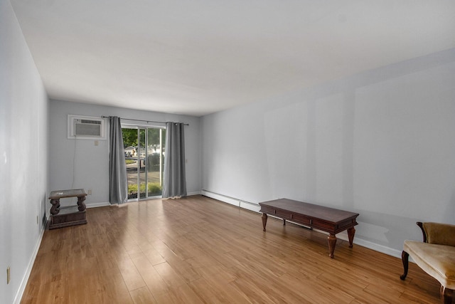 616 Lynn Ave Unit 21, Kalamazoo, MI 49008 - spare room with light wood finished floors, a wall mounted AC, and a baseboard heating unit