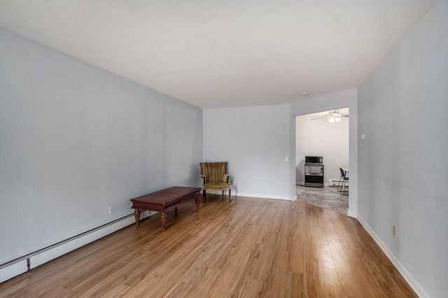 616 Lynn Ave Unit 21, Kalamazoo, MI 49008 - living area with light wood finished floors, a baseboard radiator, and ceiling fan