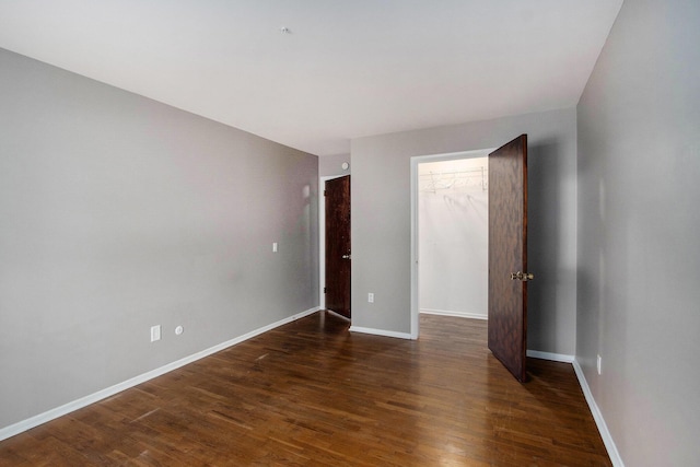 616 Lynn Ave Unit 21, Kalamazoo, MI 49008 - unfurnished room with dark wood-style flooring and baseboards
