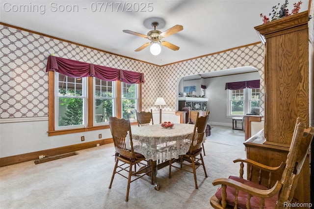2006 N Connecticut Ave, Royal Oak, MI 48073 - dining area featuring wallpapered walls, ornamental molding, carpet floors, ceiling fan, and arched walkways