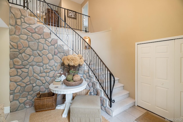 3831 Woodland Dr, Highland, MI 48356 - staircase featuring tile patterned flooring