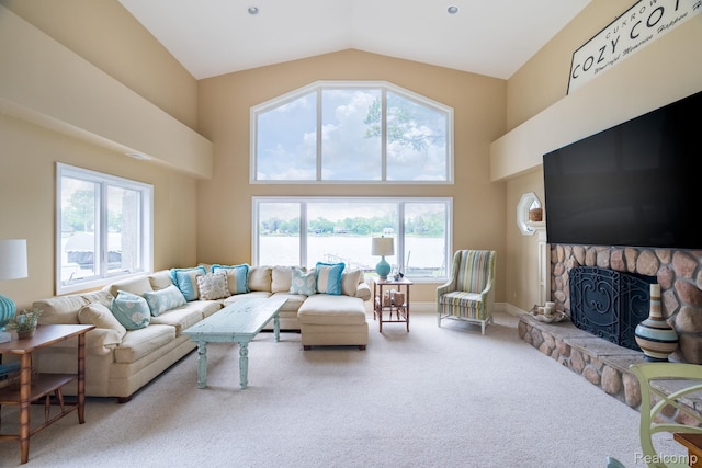 3831 Woodland Dr, Highland, MI 48356 - living room featuring carpet floors, a stone fireplace, and high vaulted ceiling