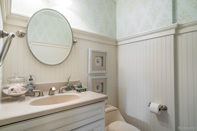 3831 Woodland Dr, Highland, MI 48356 - half bathroom with wallpapered walls, a wainscoted wall, and vanity