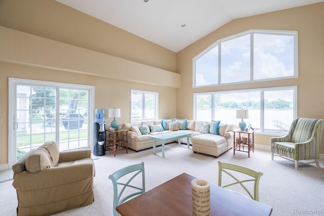 3831 Woodland Dr, Highland, MI 48356 - living area with light carpet, healthy amount of natural light, and high vaulted ceiling