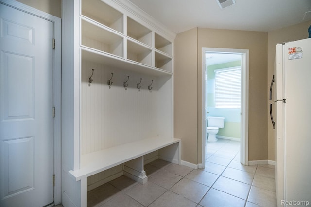 3831 Woodland Dr, Highland, MI 48356 - mudroom with light tile patterned floors and baseboards