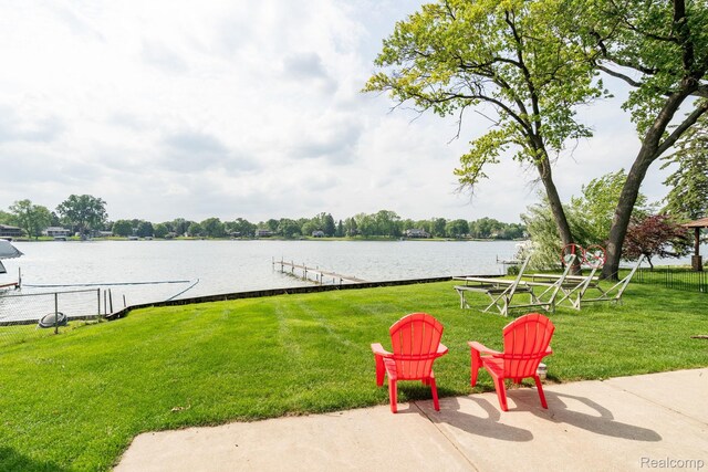 3831 Woodland Dr, Highland, MI 48356 - view of green lawn featuring a water view and a boat dock