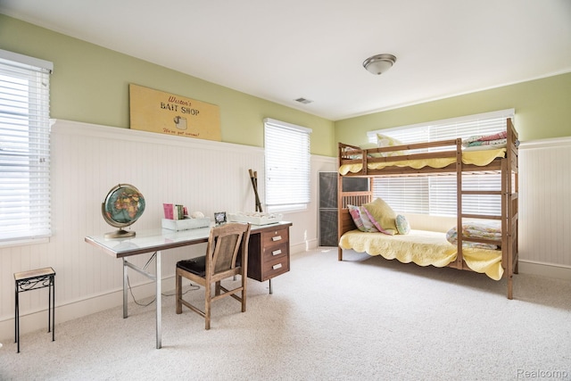 3831 Woodland Dr, Highland, MI 48356 - carpeted bedroom with a desk and a wainscoted wall