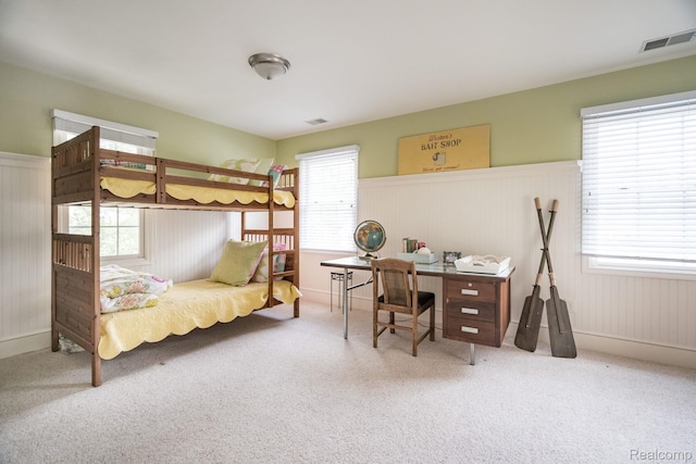 3831 Woodland Dr, Highland, MI 48356 - bedroom with carpet flooring, multiple windows, and wainscoting