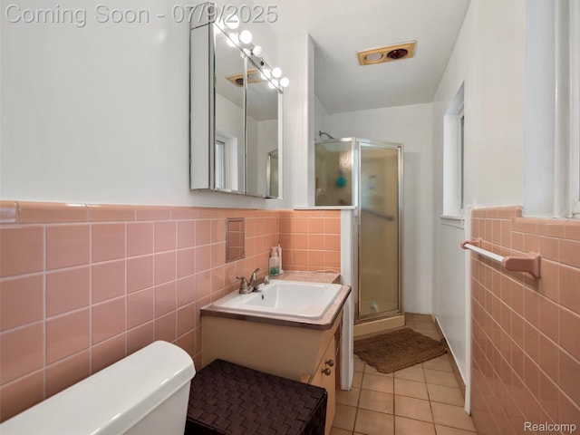 32000 Coronet Dr, Farmington, MI 48334 - full bathroom featuring tile walls, tile patterned flooring, a stall shower, vanity, and a wainscoted wall