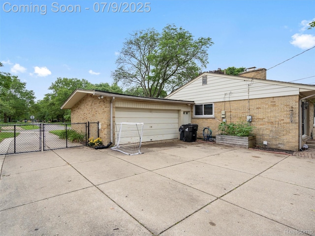 32000 Coronet Dr, Farmington, MI 48334 - view of side of home with brick siding, a chimney, driveway, and a gate