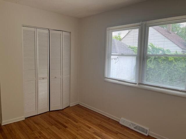 846 Hancock St SE, Grand Rapids, MI 49507 - unfurnished bedroom with a closet and wood finished floors